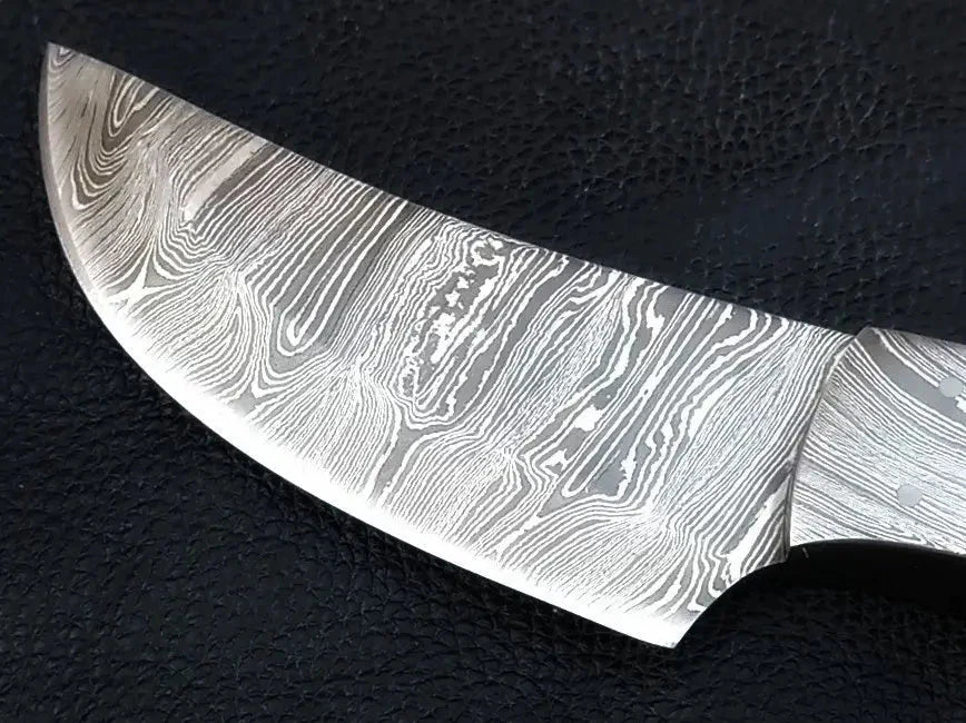 Close-up of Damascus steel knife on black surface with black background - Damascus Steel Knife-C102