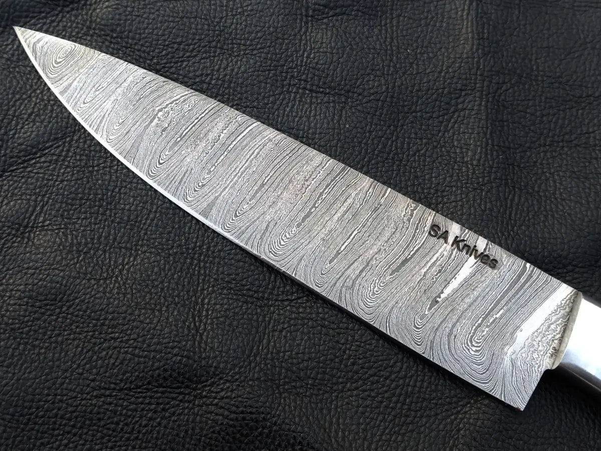 Handmade Damascus Steel Chef’s Knife on black surface