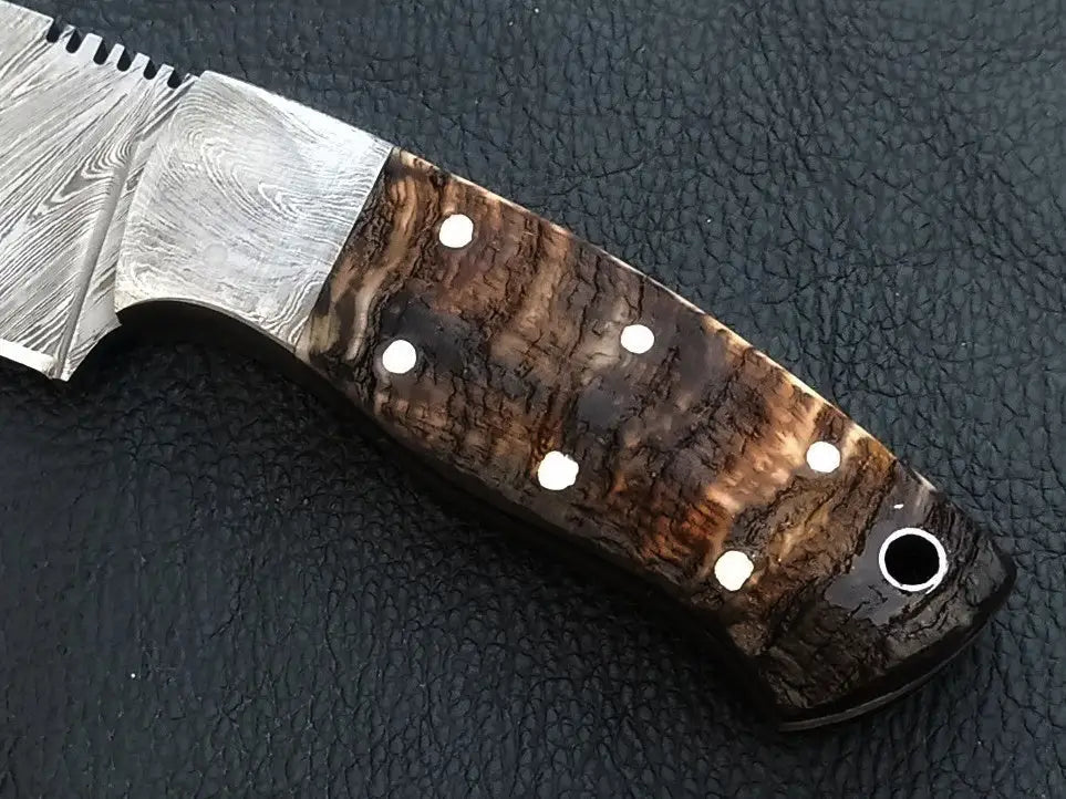 Handmade Damascus Steel Knife with horn handle, featuring intricate patterns and design