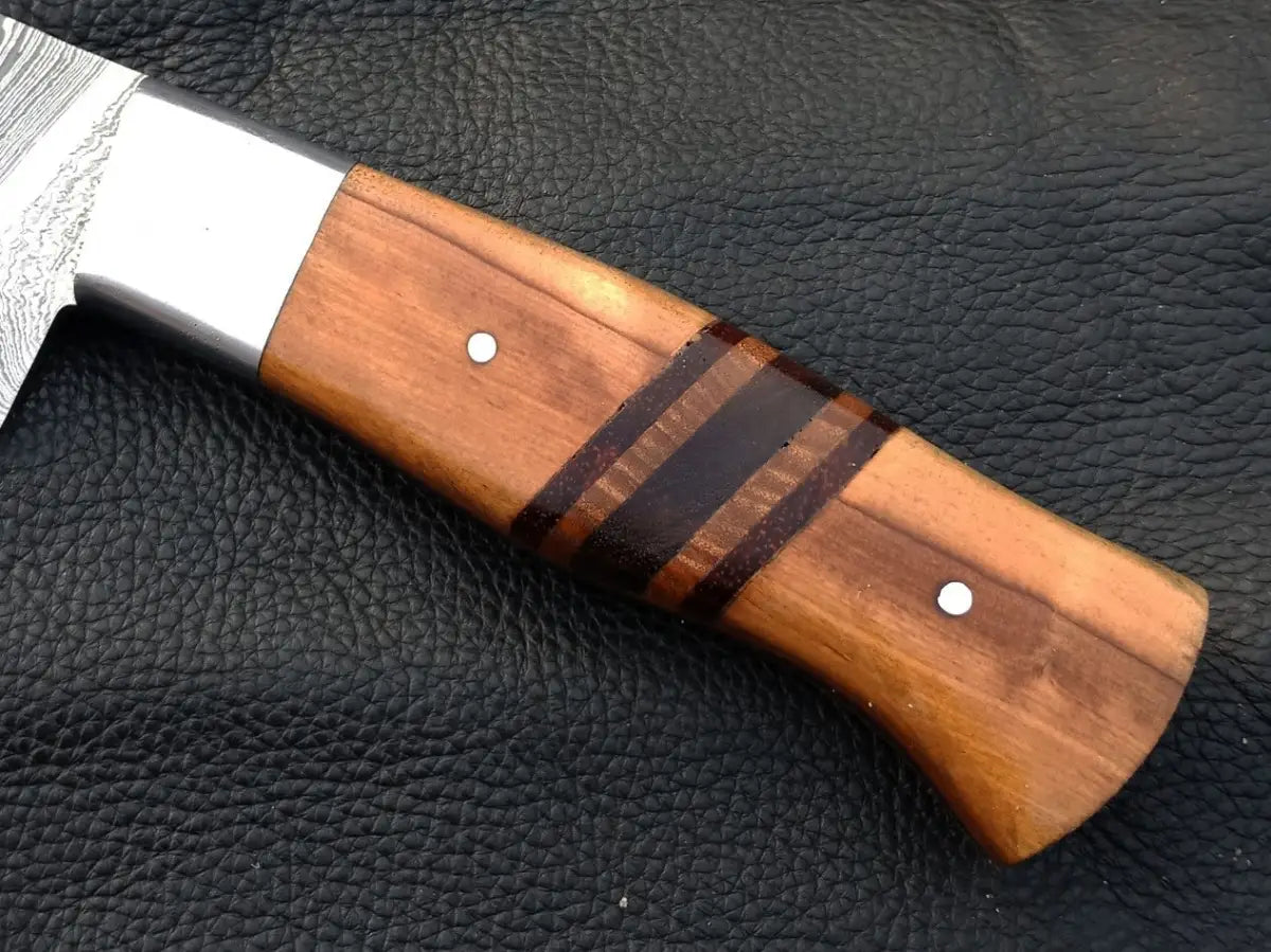 Handmade Damascus Steel Chef’s Knife with Wooden Handle on Leather Surface