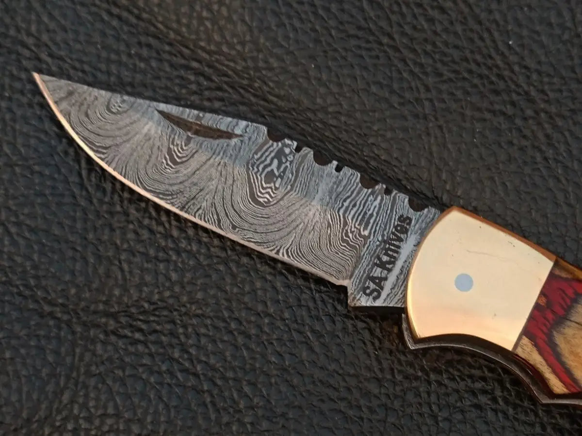 Handmade Damascus Steel Folding Knife SAF007 with intricate blade design and sturdy handle