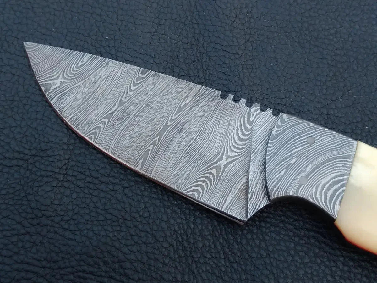 Handmade Damascus steel knife with wooden handle on black leather surface