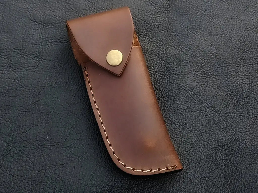 Handmade Damascus steel folding knife in leather sheath