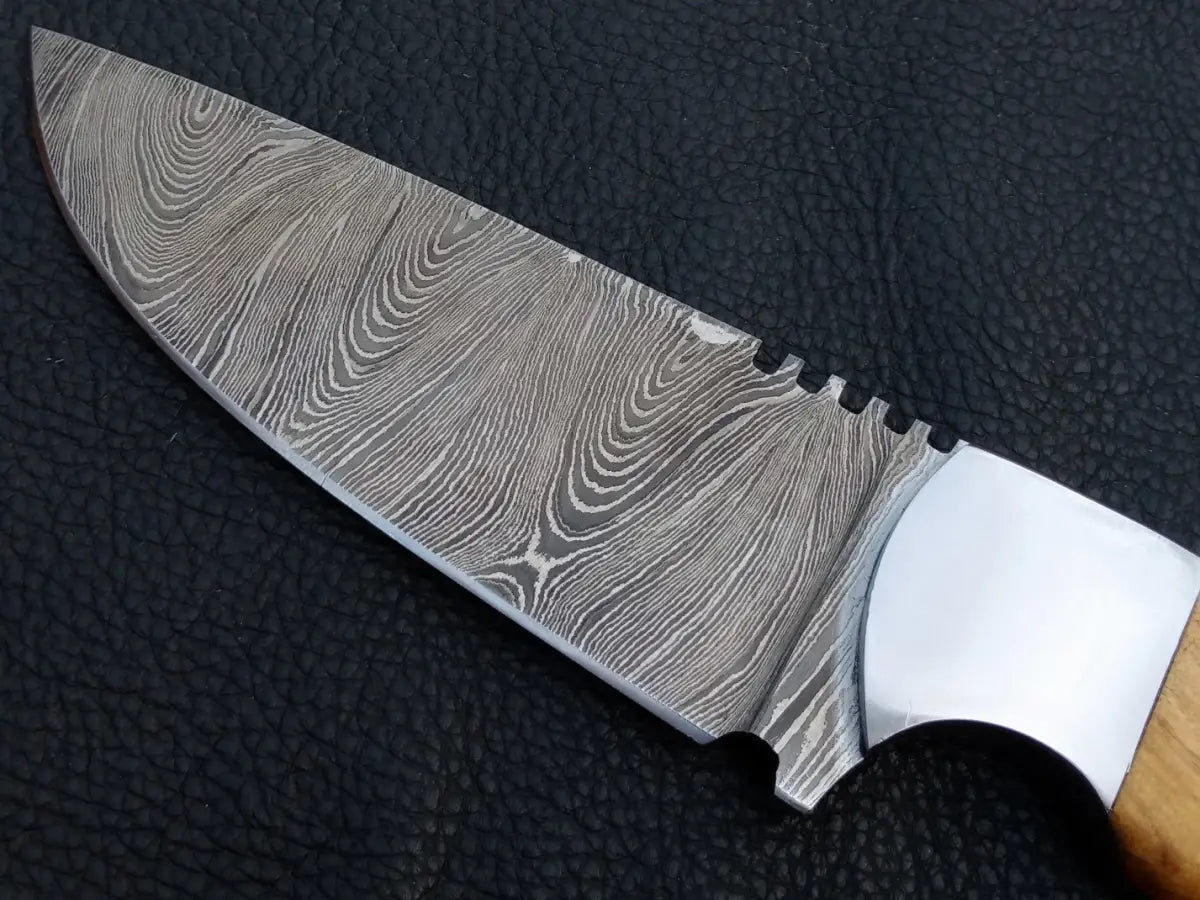 Handmade Damascus steel knife with wooden handle on black background